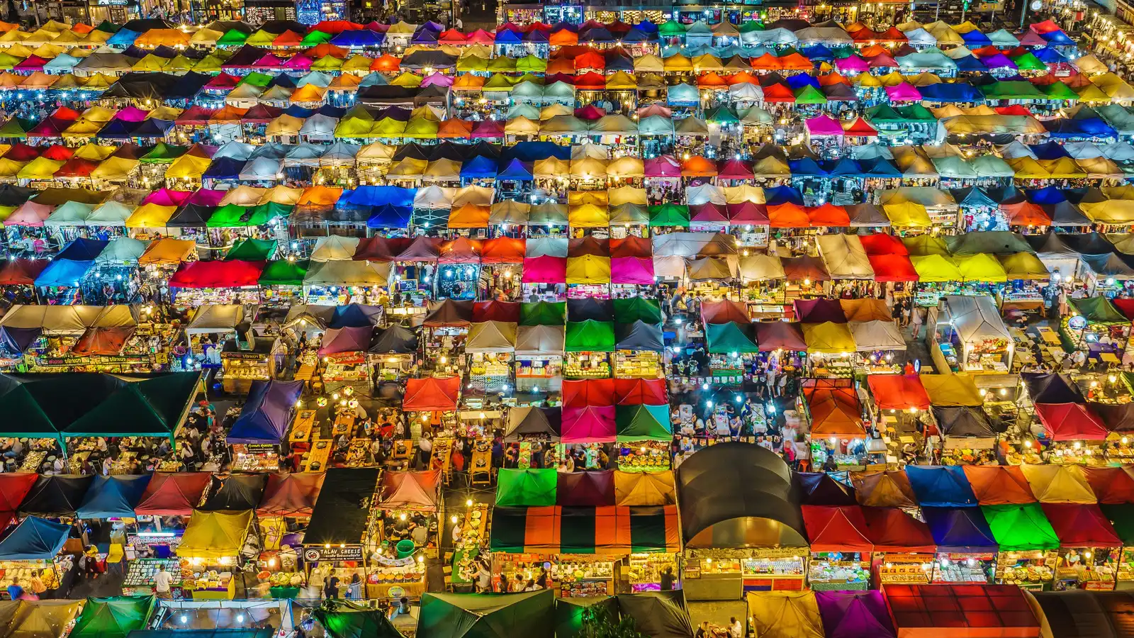 Rows of colourful tents at the Train Night Market Ratchada seen from above at night