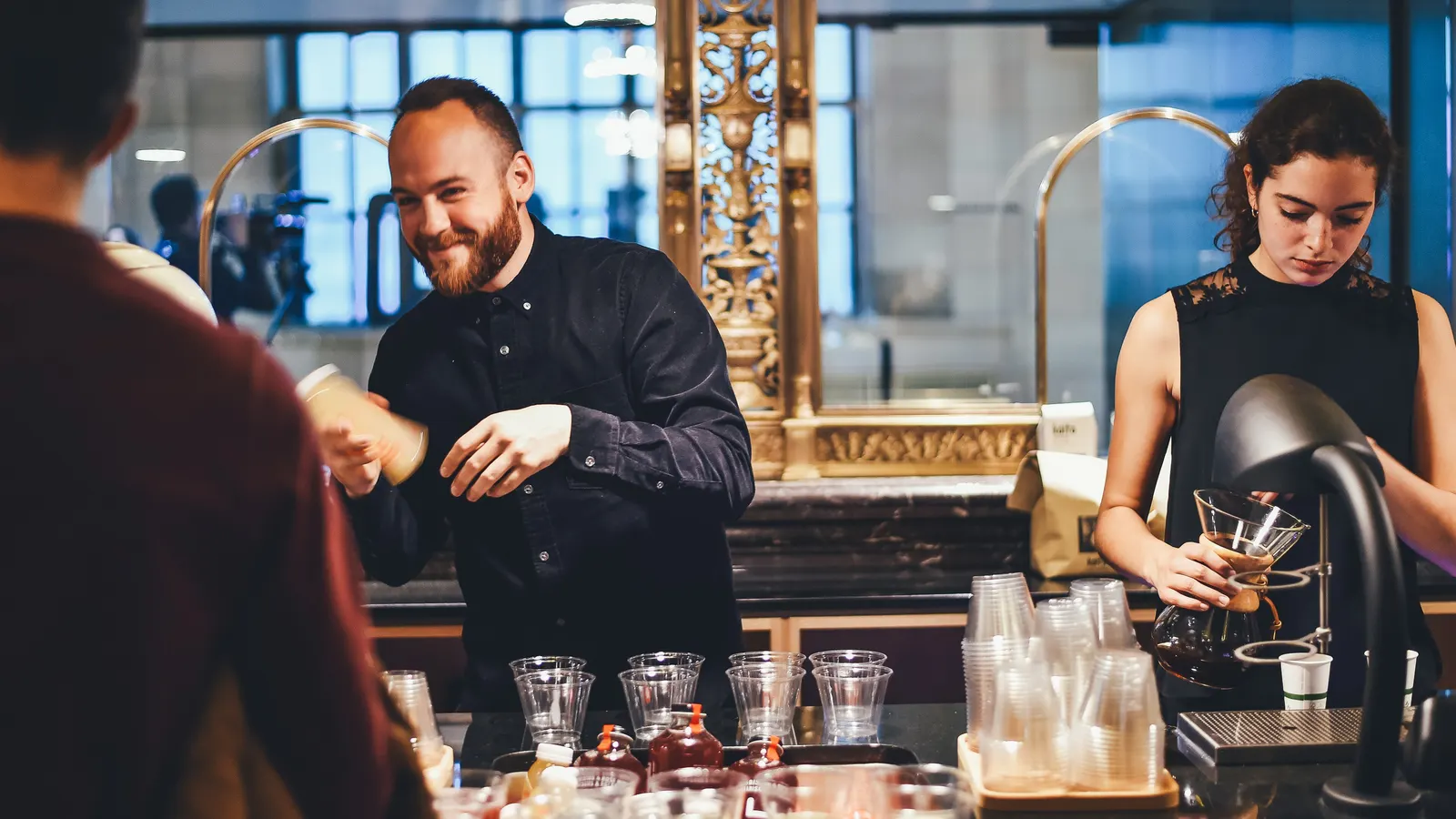 Bartenders preparing drinks behind a bar counter