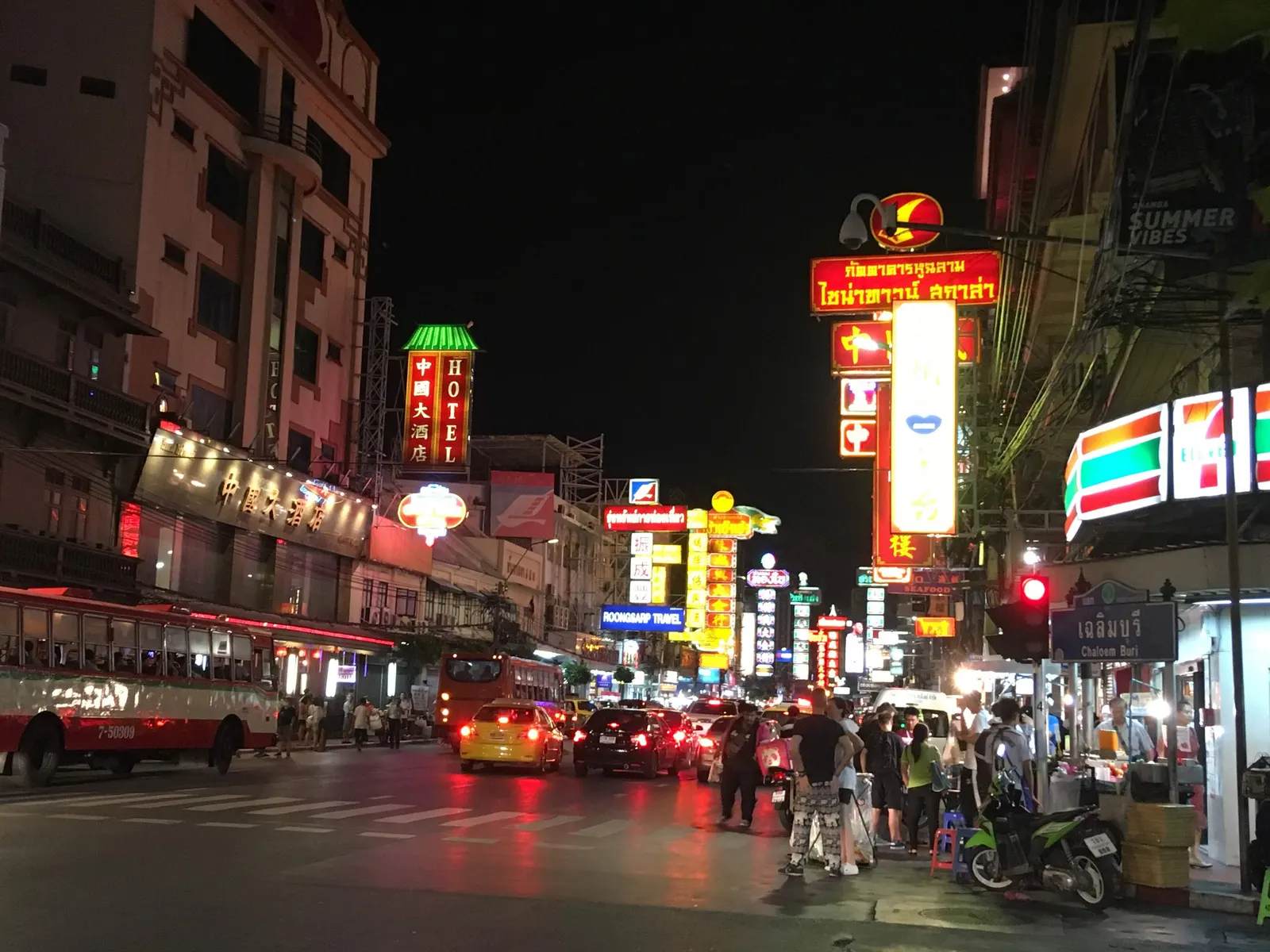 Neon shop signs in Chinese and Thai lighting up Yaowarat Road in Bangkok's Chinatown at night