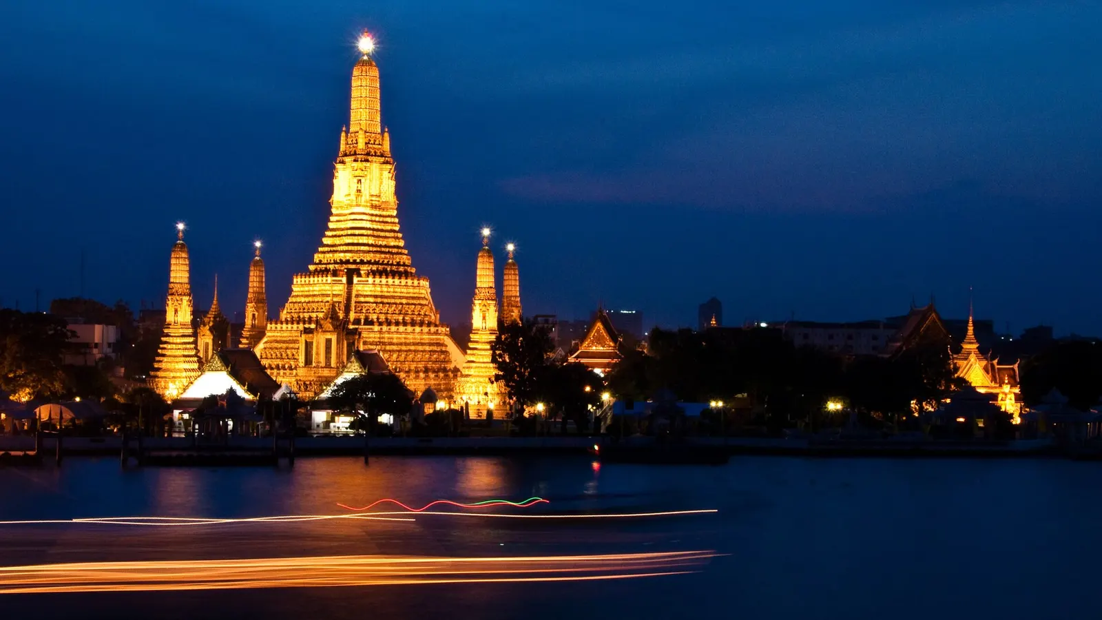 Wat Arun lit up at night across the Chao Phraya River