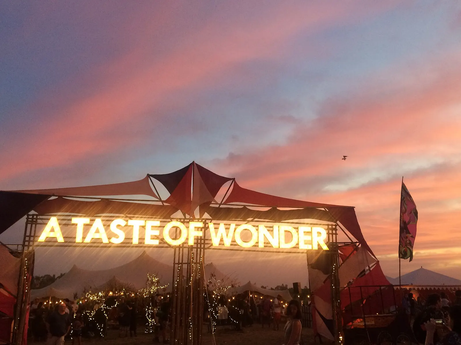 Sunset over the 'A Taste of Wonder' gate at Wonderfruit festival near Pattaya
