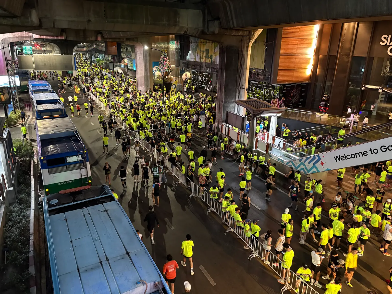 Runners in yellow shirts at the start area of the Amazing Thailand Marathon Bangkok near Siam
