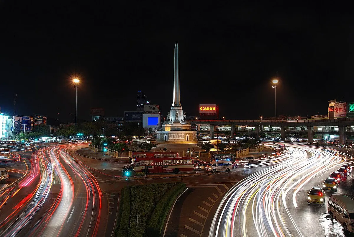 Victory Monument lit up at night, close to Saxophone Pub