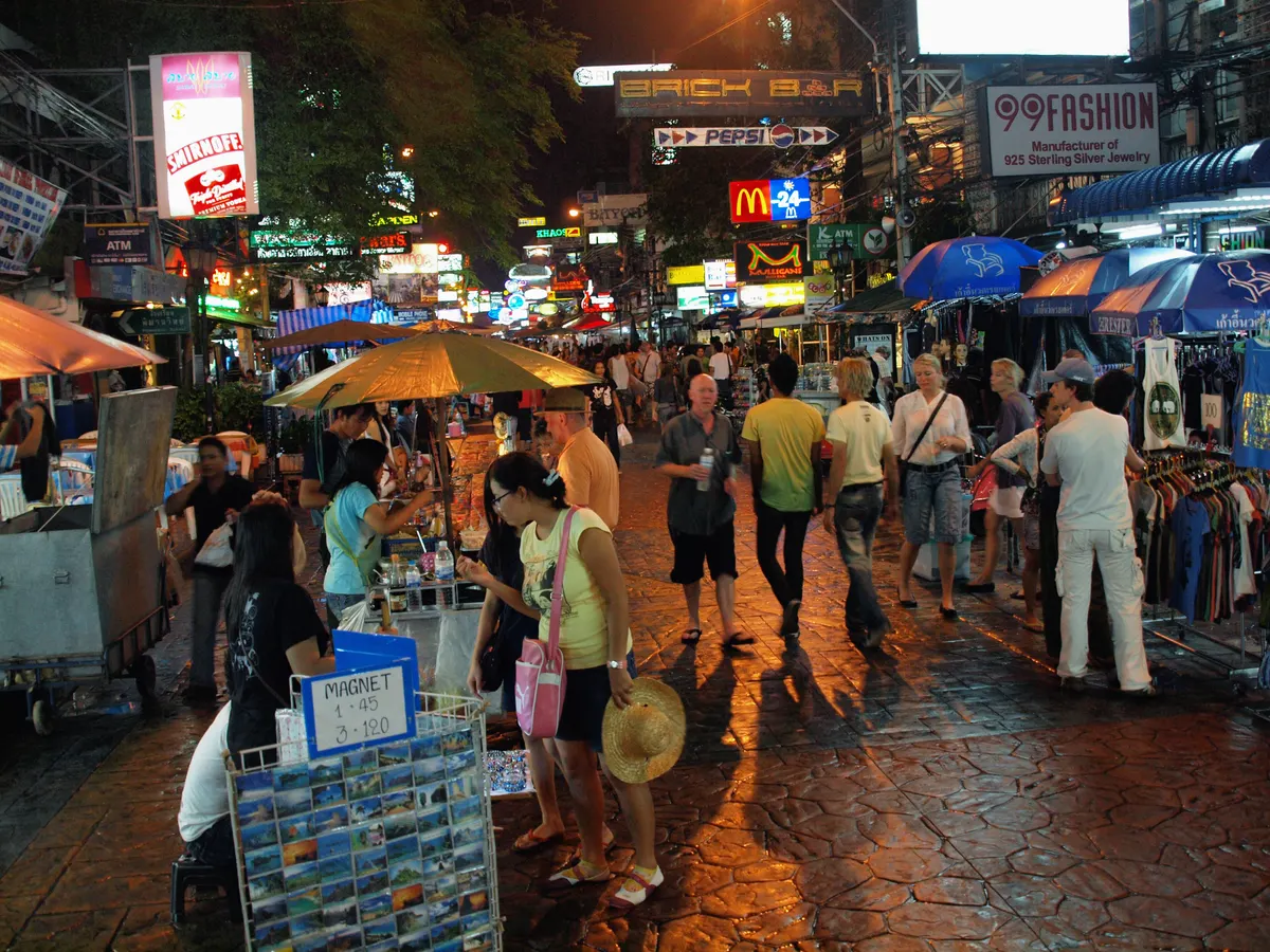 Khao San Road crowded with people and neon signs at night