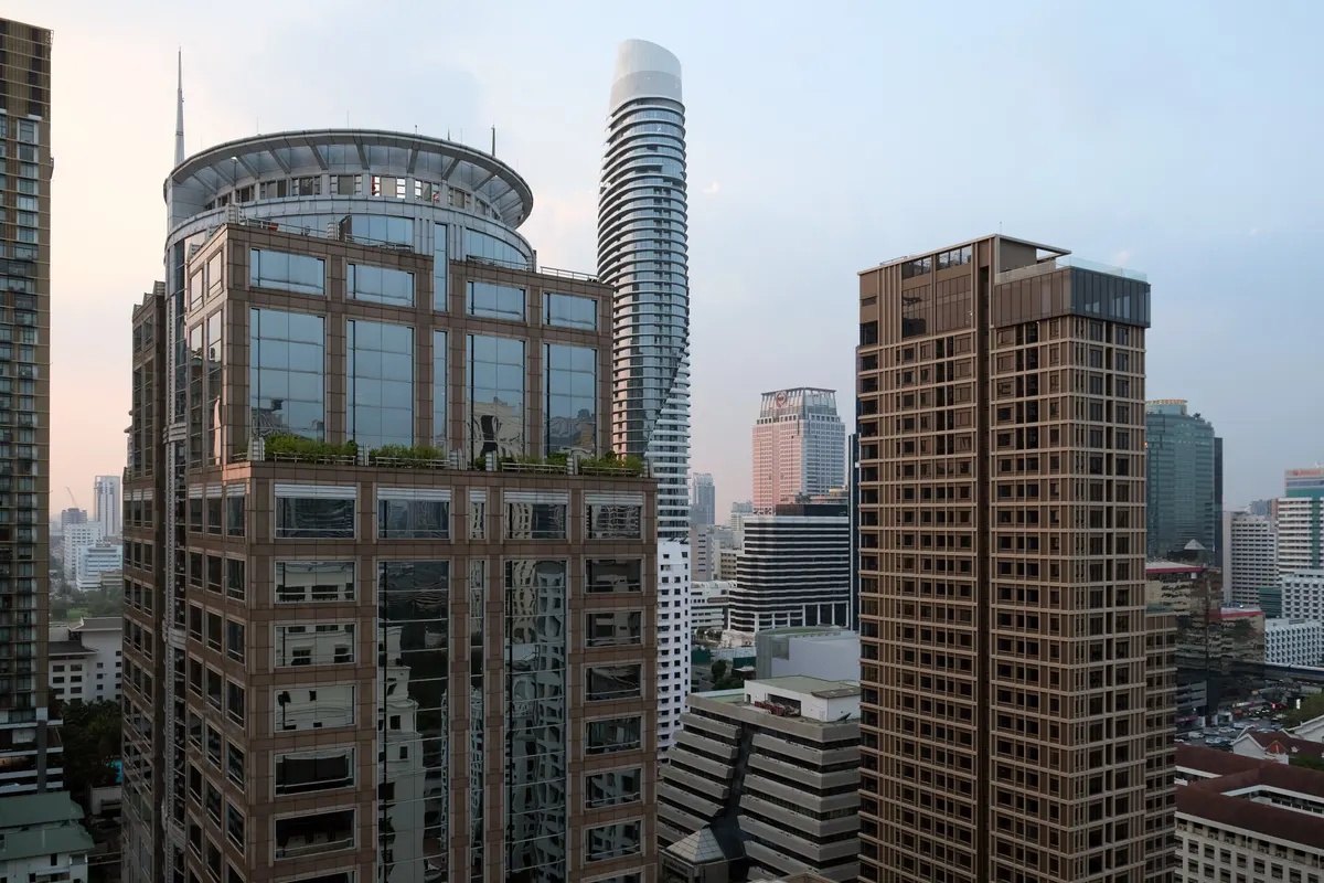 Late-afternoon view over the towers around Langsuan from The Speakeasy at Hotel Muse